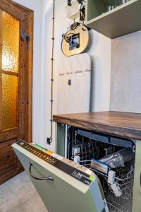 a dishwasher in a kitchen with a wooden counter at 5 Porte in Racibórz +31 photos