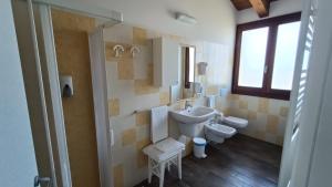a bathroom with a sink and a toilet at La Valle in Villa Verucchio