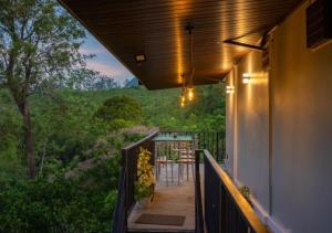 a balcony of a house with a table and chairs at Lavee Villa Ella in Ella