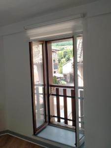 an empty room with a window with a view at La petite maison in Marchampt