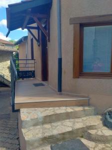 a porch of a building with a blue roof at La petite maison in Marchampt