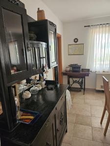 a kitchen with a black counter top and a table at Villa Jaz in Seline