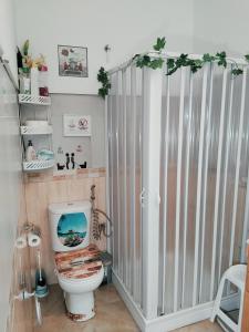 a bathroom with a shower with a toilet in it at La casita de la vito in Illar +105 photos