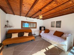 two beds in a room with wooden ceilings at La cabane les pieds dans l'eau, accès direct au lac d'Annecy in Doussard