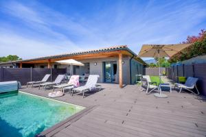 a patio with chairs and a pool and an umbrella at Résidence Pierre & Vacances Premium Vesna Rossa in Porto-Vecchio +32 photos
