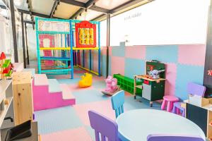 a room with a play area with tables and chairs at ELIA MARe Hotel ALL Inclusive - Free Beach Access in Kiten
