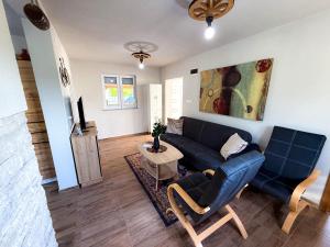a living room with a couch and a table at Grmec Cabin Rental in Podgradina