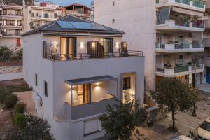 an aerial view of a white building with a rooftop at Grava Aurum - City Suites in Igoumenitsa +66 photos