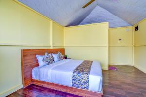 a bedroom with a large bed in a room at Hotel Briko Lodging & Resort in Nashik