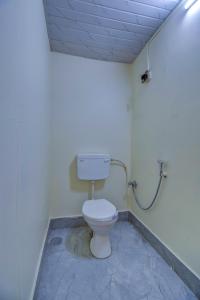 a bathroom with a toilet in a room at Hotel Briko Lodging & Resort in Nashik +21 photos