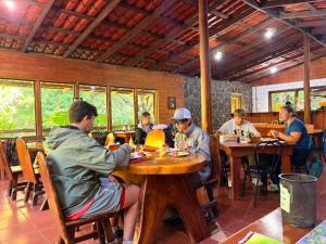 a group of people sitting at tables in a restaurant at Elida Lodge Monteverde in Monteverde Costa Rica