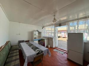 a room with a bed and a large window at All Home in Cholpon-Ata