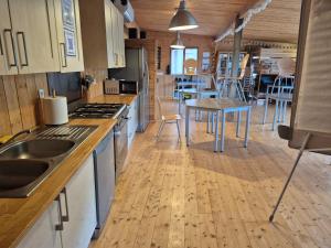 a kitchen with wooden floors and a table and chairs at Gite équestre in Les Hogues