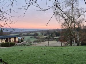 a view of a field with a house at Gite équestre in Les Hogues