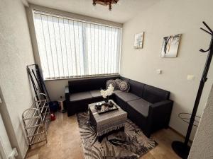 a living room with a couch and a table at Grmec Cabin Rental in Podgradina