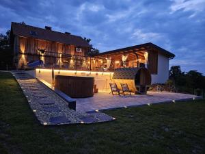 a large house with a patio and a building at Vila RAMI in Donja Poljana
