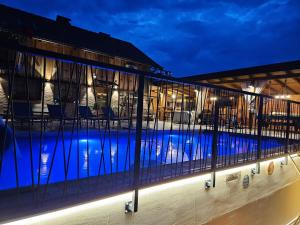 a view of a swimming pool at night at Vila RAMI in Donja Poljana
