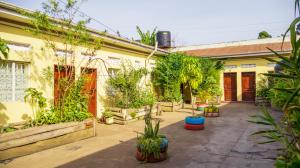 a courtyard of a house with potted plants at SuPas Bistro in Kisoro