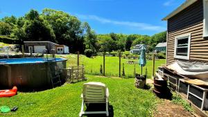 a yard with a chair and a swimming pool at Humble beginning 605 EM in Norwich