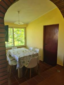 a dining room with a table and white chairs at Casa vacanze a Roccella Jonica in Roccella Ionica