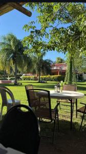 a white table and chairs in a park at Casa AONIKENK in Villa Dolores