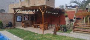 a house with a wooden pavilion on a patio at villa vilcar in Cali