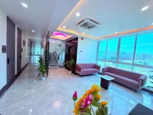 a living room with purple furniture in a building at Hotel Purple Lotus Suites in Chauk