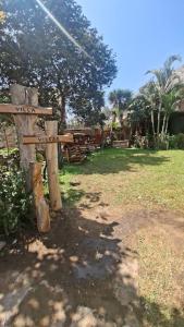 a wooden sign sitting on top of a tree stump at villa vilcar in Cali