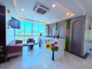 a hotel lobby with a reception desk and a tv at Hotel Purple Lotus Suites in Chauk +55 photos