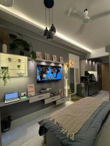 a bedroom with a flat screen tv on the wall at The cozy corner in Ghaziabad