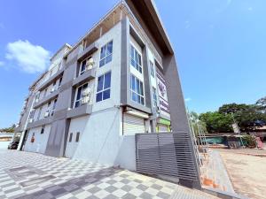a large white building with a lot of windows at Hotel Purple Lotus Suites in Chauk