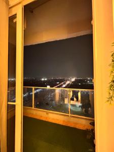 a view of a city at night from a balcony at The cozy corner in Ghaziabad