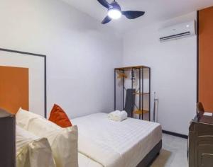 a bedroom with a bed and a ceiling fan at Blue aura in Kuala Lumpur