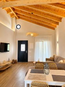 a living room with a couch and a table at Olea Verde Loft Apartment in Lefkimmi