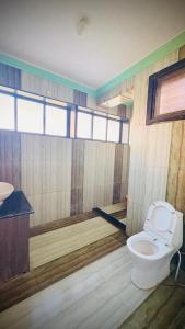 a bathroom with a toilet and a sink at Rooftopwaves penthouse in Daman
