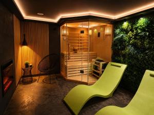 a bathroom with a green chair and a shower at GreenHouse pool & spa in Otruševec