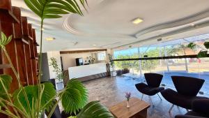 a living room with a table and some plants at Atlas Beach Hotel in Fortaleza
