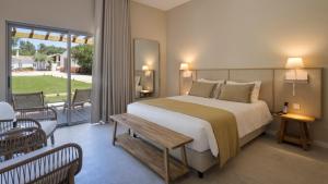 a bedroom with a large bed and a balcony at VILLA BRANDA - Tavira Nature Hotel in Tavira +85 photos