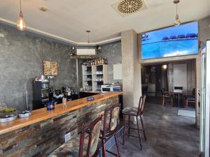 a bar in a restaurant with chairs and a large screen at Bruchsal Herz in Bruchsal