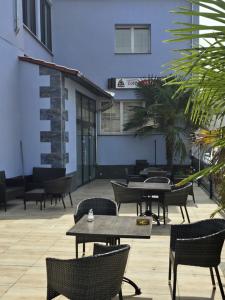 a patio with tables and chairs and a building at Bruchsal Herz in Bruchsal