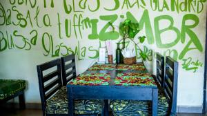 a blue table with a colorful table cloth on it at SuPas Bistro in Kisoro