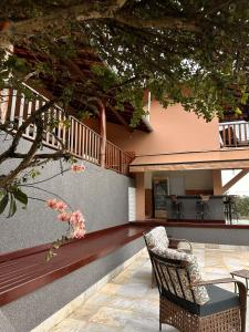 a patio with a table and chairs and a house at Pousada Jamacaii in Araxá