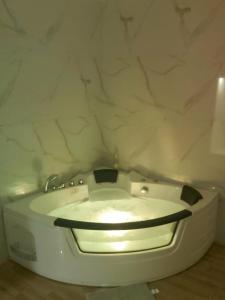 a white toilet in a bathroom with a marble wall at Villa Ronić in Soko Banja