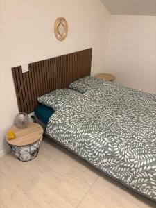a bedroom with a large bed with a wooden headboard at L escapade pro in La Roche-Chalais +4 photos