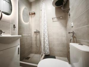 a bathroom with a shower and a toilet and a sink at Apartmani Vukovic in Budva +21 photos