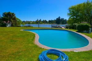 a swimming pool with a lake in the background at Lake Rapel, beautiful lake view in Las Cabras