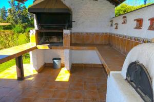 an outdoor kitchen with a pizza oven on a patio at Lake Rapel, beautiful lake view in Las Cabras