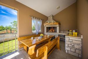 a dining room with a table and a fireplace at Villa Karla, private pool, 3 bedroom in Divšići