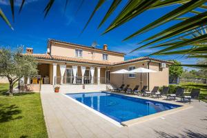 a villa with a swimming pool and a house at Villa Karla, private pool, 3 bedroom in Divšići