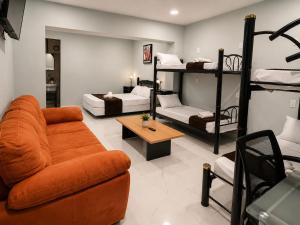 a living room with a couch and bunk beds at Hotel Boutique Venecia Cdmx in Mexico City